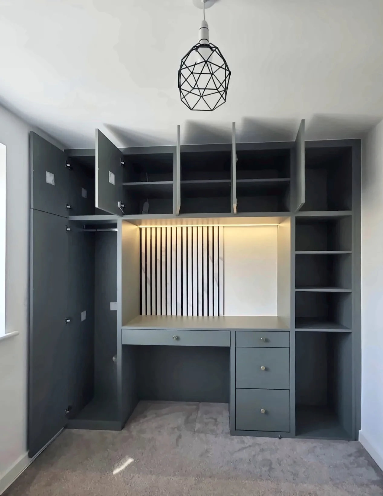 The same Yadani home office with the cupboard doors open to show the storage inside