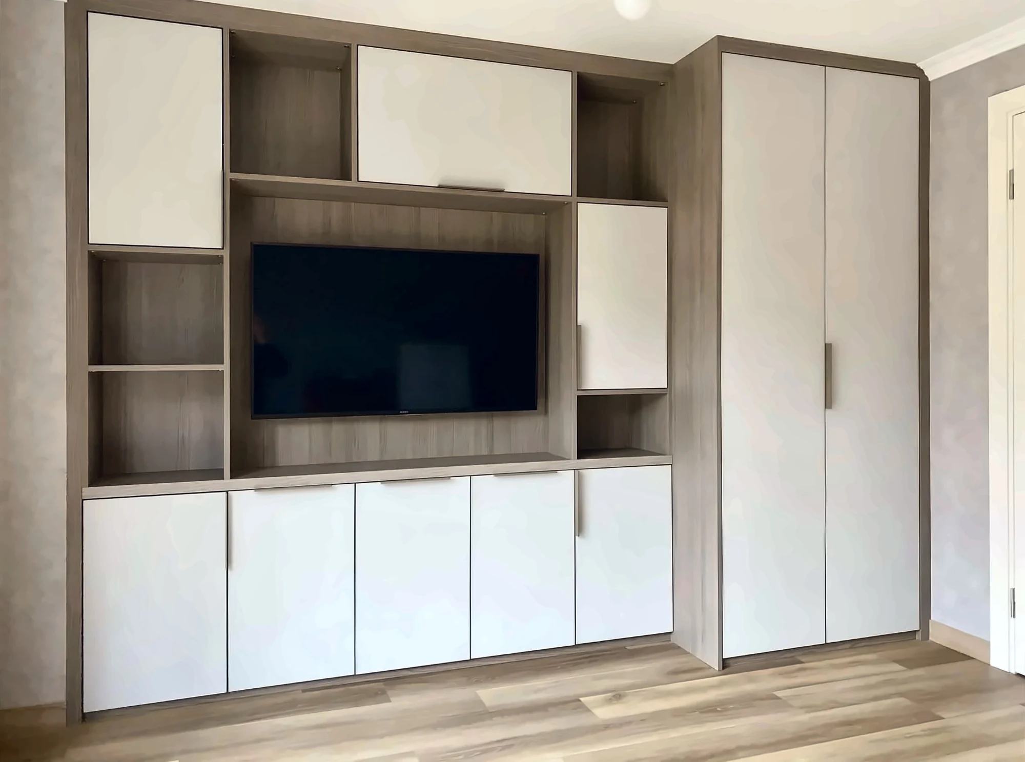 Completed Yadani TV unit and matching fitted wardrobe in oak-effect and white
