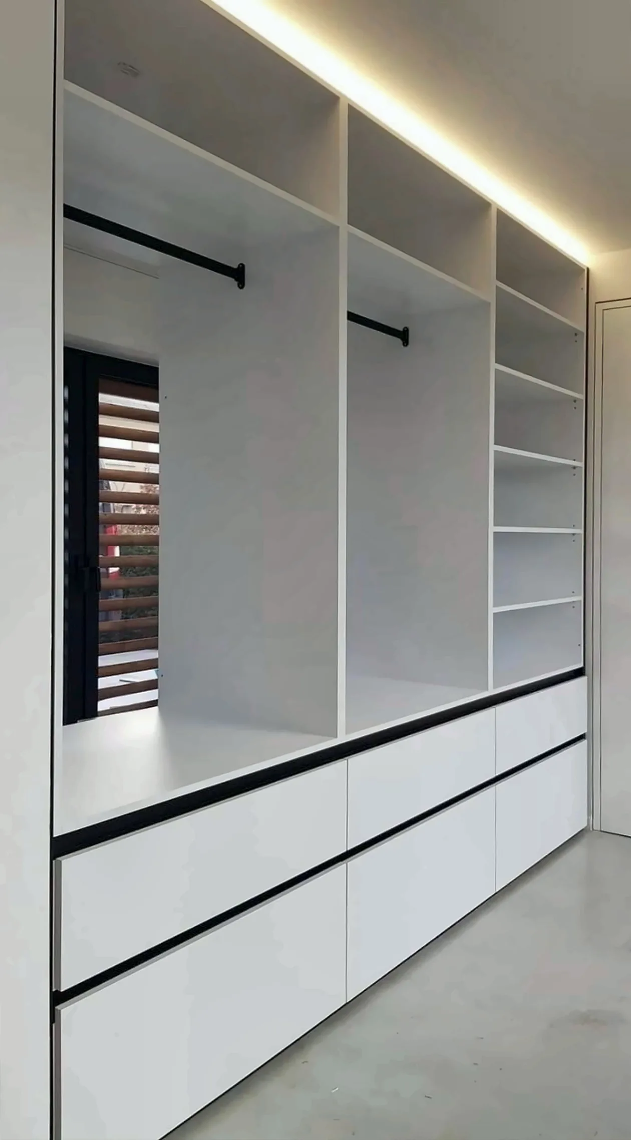 Completed Yadani fitted wardrobe with hanging rails, shelves and drawers