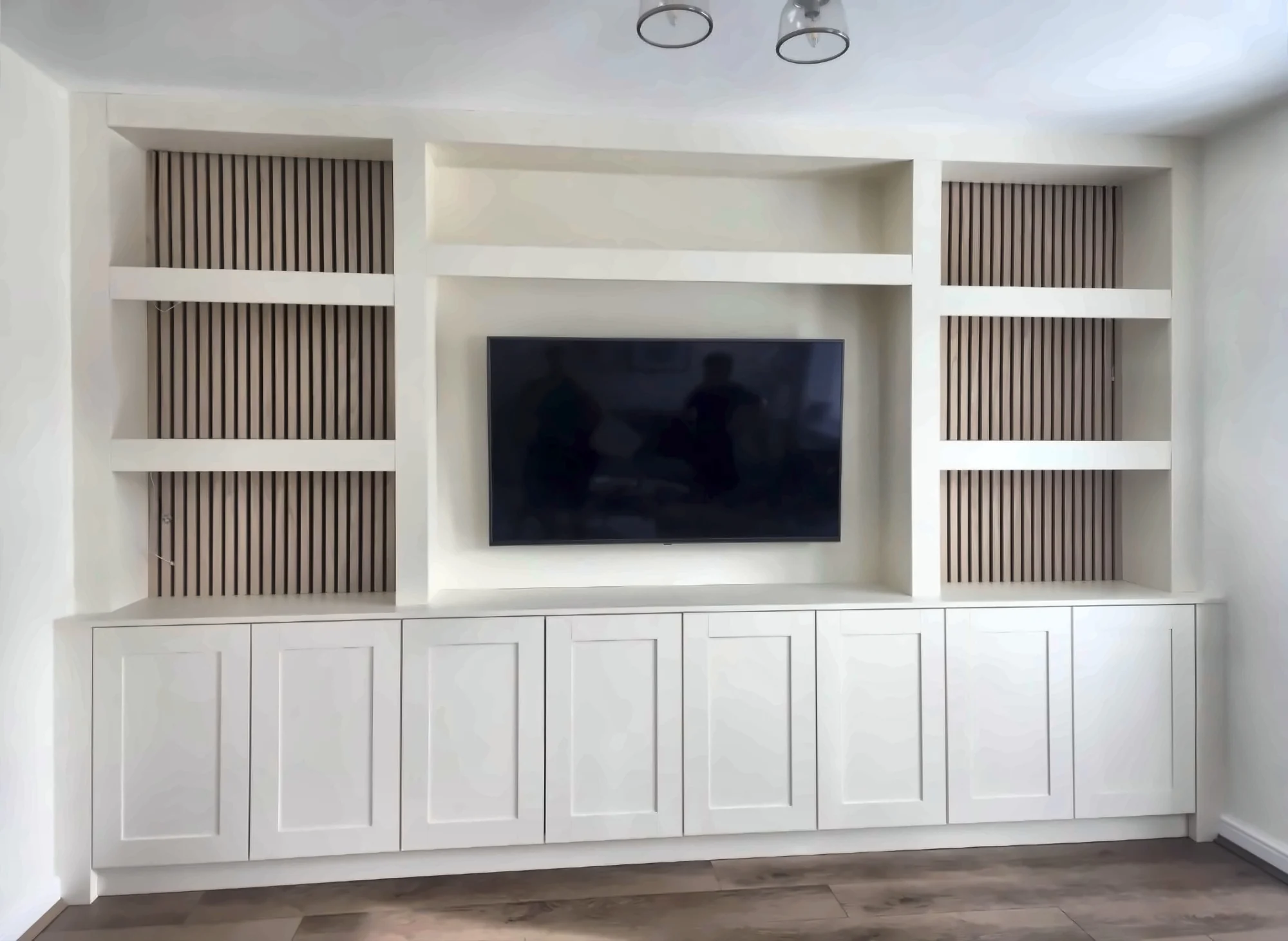 Completed Yadani white Shaker media wall with slatted alcoves